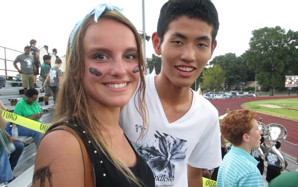 New exchange students Cecile Kessler  and Shunichi Haraguchi cheer on  the Spartan football team at the first home game of the season.  