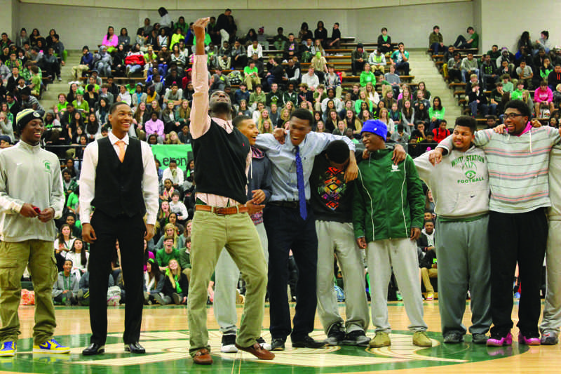 Members of the Spartan basketball team celebrate being introduced at the Pep Rally for the Homecoming game against East High.