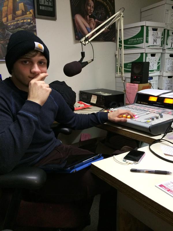 Mabray sits in the WEVL studio as he selects music for his next show. Courtesy of Mallory Prater