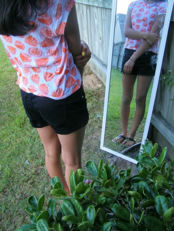A young girl looks at herself in her mirror and sees her insecurities. 

