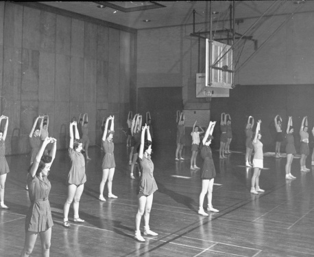 Students enjoying calisthenics during gym class at their all white high school.