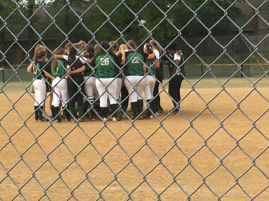 The Lady Spartans and FACS Crusaders in a group huddle after the game on April 18.  