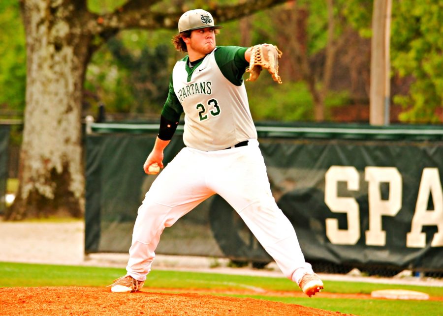 Reed McGuinn (12) pitches a fastball during a game.
