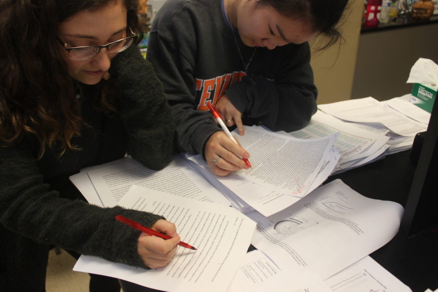 Kirsten Todd (12) and Shannon Donlon (12) proofreading papers.
