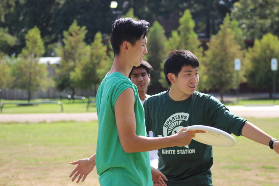 Justin Du (12) coaches Alex Chung (12) during practice at Audubon Park.