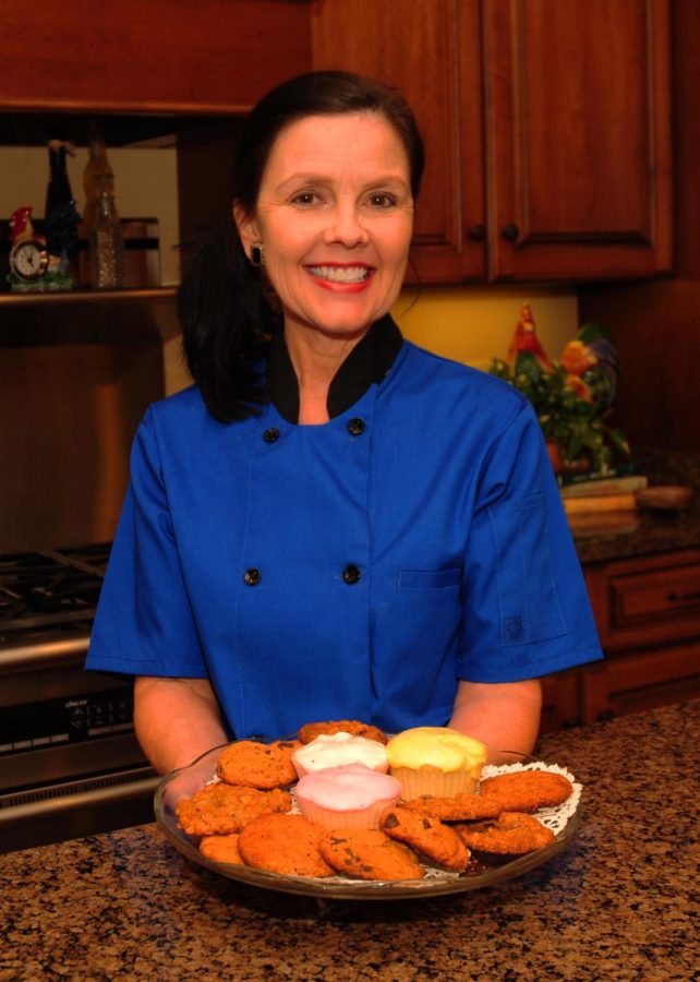 Mrs. Whittington stands in her kitchen with a batch of freshly baked cookies.