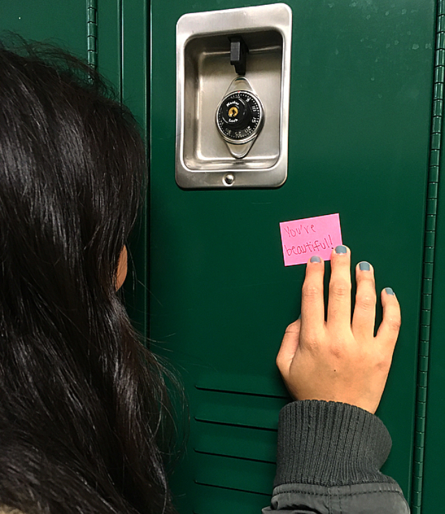 Student Darya Orgil (10) reads an encouraging note on her locker.