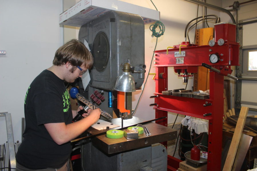 Evans works on building a robot in an MLGW worker’s machine shop after school for a competition in Huntsville from March 15 to 17.