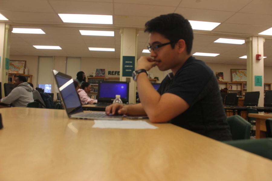 Poet Victor Arroyo (11) works on a new piece of writing in the library after school. 

