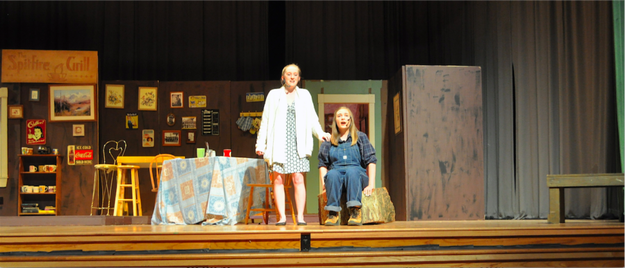 Claire Brindley and Rachel Thomas singing onstage during the musical