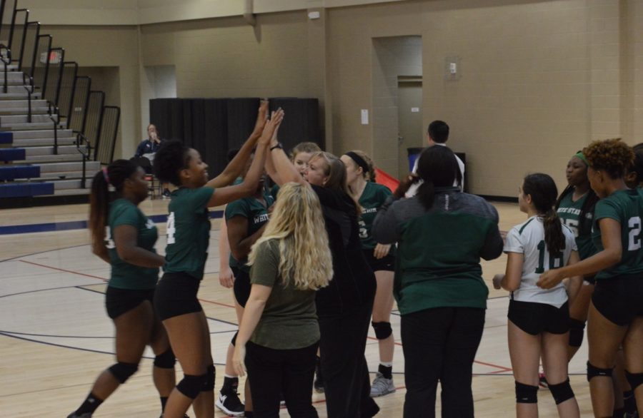 Lady Spartans Varsity team meet for a huddle to boost morale in the middle of the fourth set.