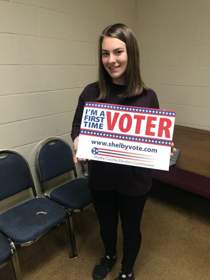 After voting for the first time, Zoe Woody (12) proudly holds the first time voter sign. 
