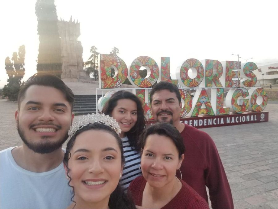 Karely Rodriguez (11) and her family pause to take a picture in front of the entrance to Dolores Hidalgo, Mexico, the city they are visiting to celebrate Karely’s sister ’s quinceañera. 
