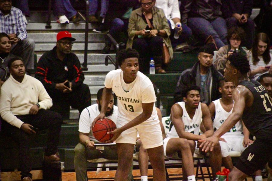 Davon+Barnes+looks+to+pass+in+a+game+against+rival+Whitehaven.+As+the+starting+small+forward+for+the+Varsity+basketball+team%2C+Barnes+has+many+responsibilities+both+on+and+off+the+court.%0A