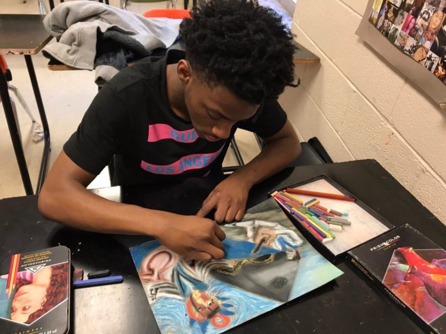 Avonte Lyles (12) blends colors on a piece. Though he usually works in charcoal, art teacher Charles Berlin pushes him to work with other mediums as well.
