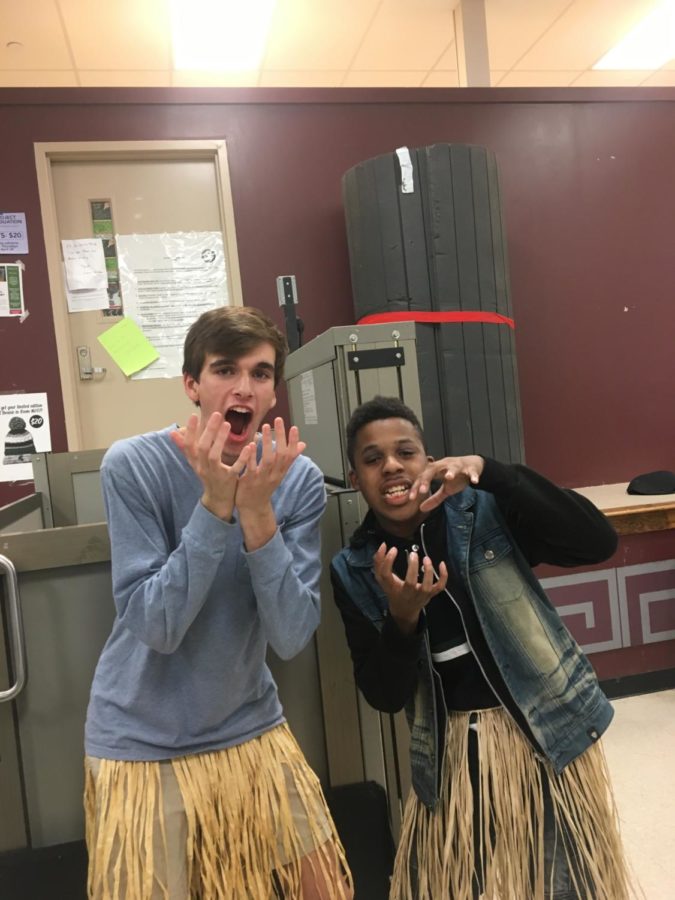 Carson Wright (12) and Martenez Jones (12) get to know each other and bond by wearing grass skirts to the initial meeting party of the Best Buddies club.
