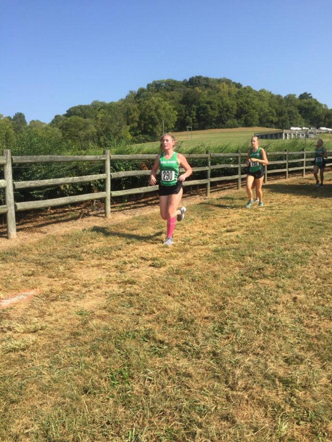 Mary Hatley (11) and Emma Shadow (12) push through the heat at the AF Bridges Invitational. Shadow finished first on the team, and Hatley finished fourth 
