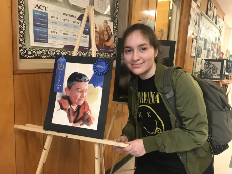 Anahis Luna (11) is with her watercolor piece, which won first place in the Midsouth Art Fair competition. The piece depicts Luna’s younger cousin.