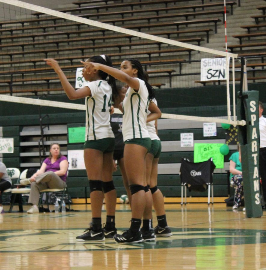 On their senior night, Devyn Davis (12), Taryn Eddie (12), Dayla Rhodes (12), and the rest of the volleyball team prepared for the second set against Southwind. They won the game in three sets.