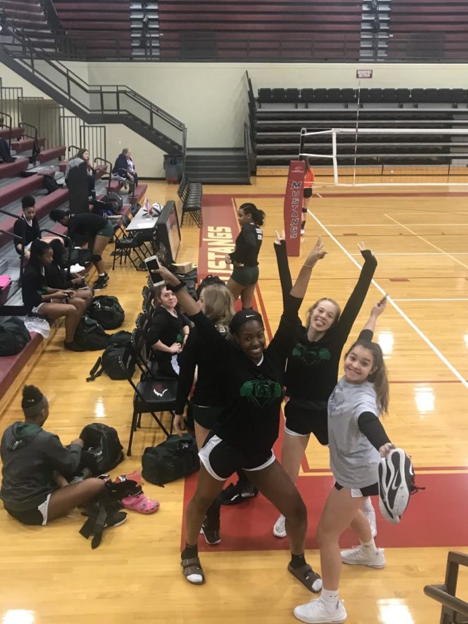 Lauren Roberts (10), McKenzie Cornell (11) and Isabella Garza (10) show their excitement about their first game of the Quad State Tournament in Paducah, Ky. The Lady Spartan volleyball team lost the game against Piggott 2-0. 
