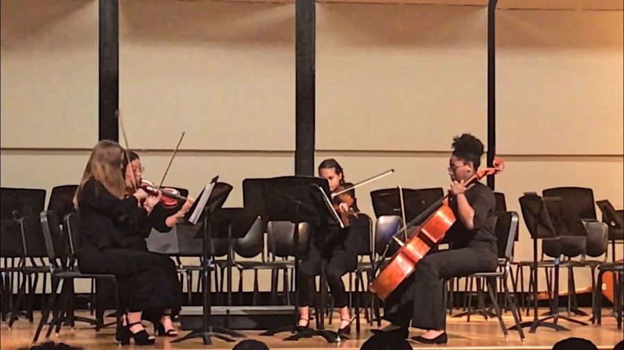 Zoe Wolfe (11), Lily Zeng (11), Abby Cassius (10), and Autumn Bobo (11) take to the stage at the fall orchestra concert and played an arrangement by Shostakovich. Wolfe and Zeng play violin, Cassius plays viola, and Bobo plays cello.