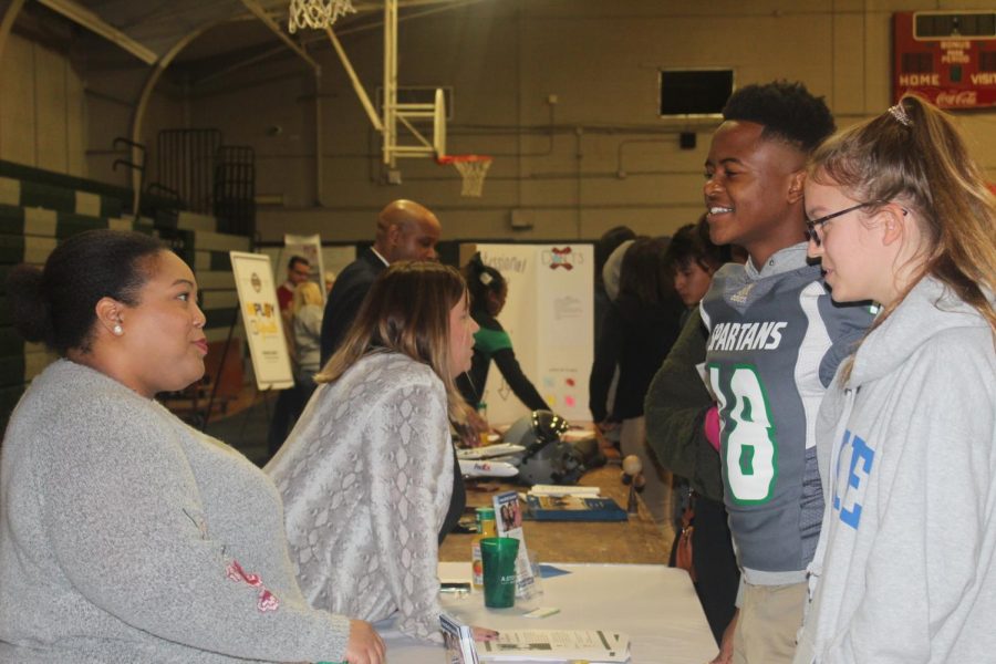 Vance Gieselmann (11) and Antonyio Walker (11) interact with a representative at a half-day career fair. The career fair allowed Spartans to explore their interests. 
