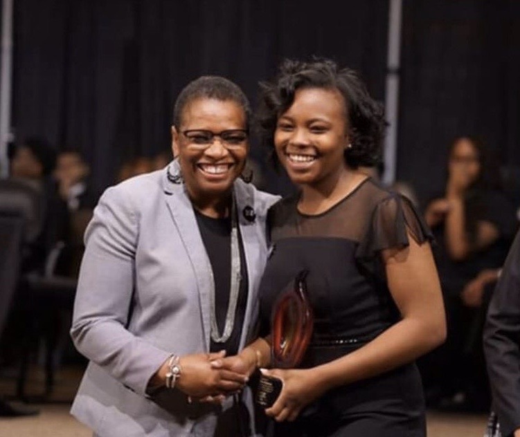 Marissa Pittman (12) shakes hands with Bathsheba Sams, the Senior Vice President of Human Resources for International Paper. The Keeper of the Dream award was established by the National Civil Rights Museum in honor of Dr. Martin Luther King Jr. 
