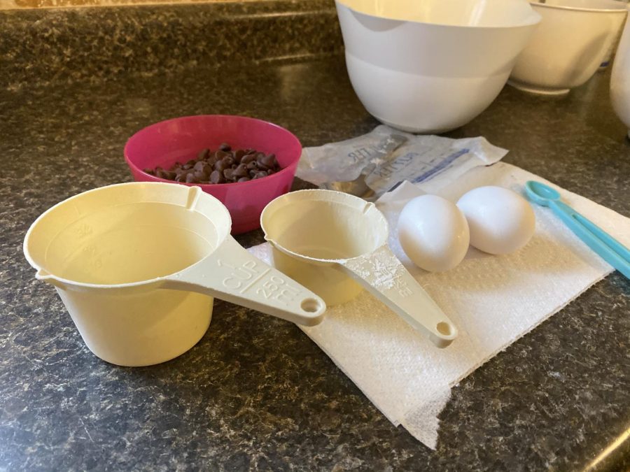 The ingredients and measuring cups for chocolate crinkle cookies lie on my counter, waiting to be used to create decadent cookies. In my opinion, cookies are the ultimate sign of the holiday season. 