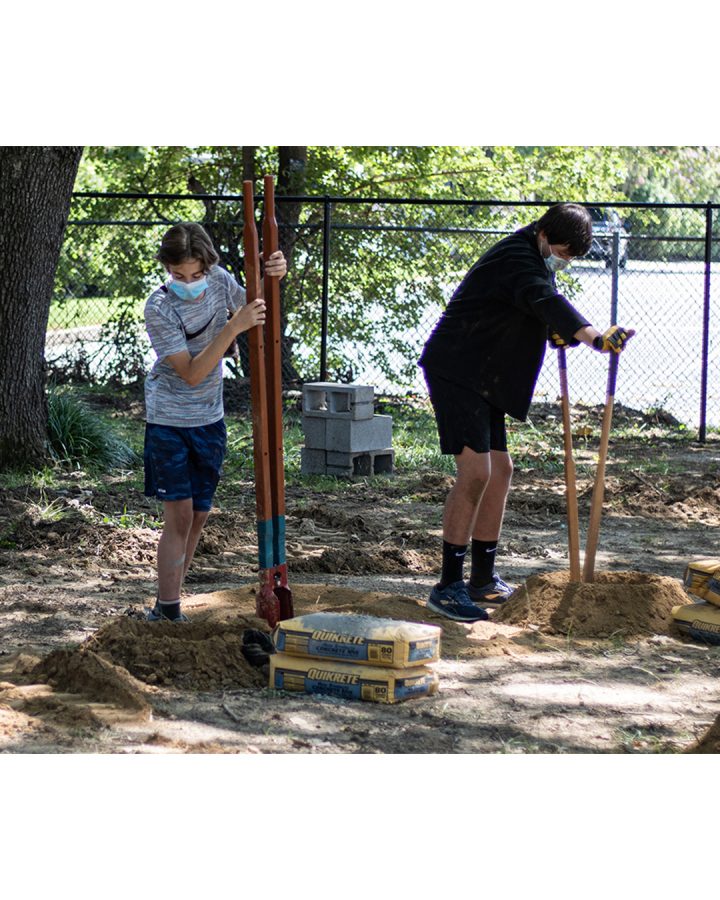 Axel Miller (9) and Jordan Kirby (9) dig holes in preparation for wooden posts for an obstacle. Over the course of five days, volunteers came and helped construct the Jerry Hiemer JROTC Leadership Course at WSHS.