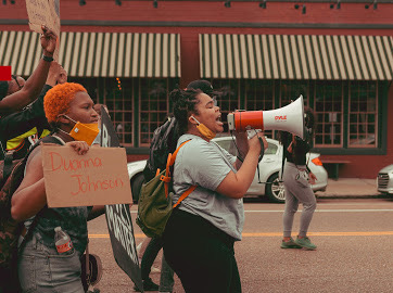 Marching down Madison Avenue, Jordan Occasionally and Allyson Smith lead chants calling for the defunding of police. Their August 1st protest drew both support and resistance from the Midtown community as they travelled from Overton Square to Cooper Young.


