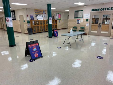 Teachers and Administration prepare for a populated school day by placing socially distanced markers in the hallways and pathways around the school. After being vacant for months, this grand entrance could be seeing visitors soon. 
