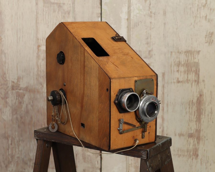 The school day cameras used by Brys Portrait Studio in the 1950s boasted simple technology: limited mobility, a large outer shell and a long line of film within the interior. On the side of the cameras, washers attached to string would be held in front of the lens by the photographer to artificially focus the camera. 