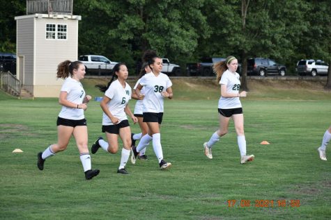 Charged with pent-up energy from last year’s nonexistent season, the girls soccer team warms up and prepares to play their first game in a season with only one team instead of the regular two. Seniors experience their last season in a unique way, and underclassmen prepare to play alongside their veteran varsity counterparts.
