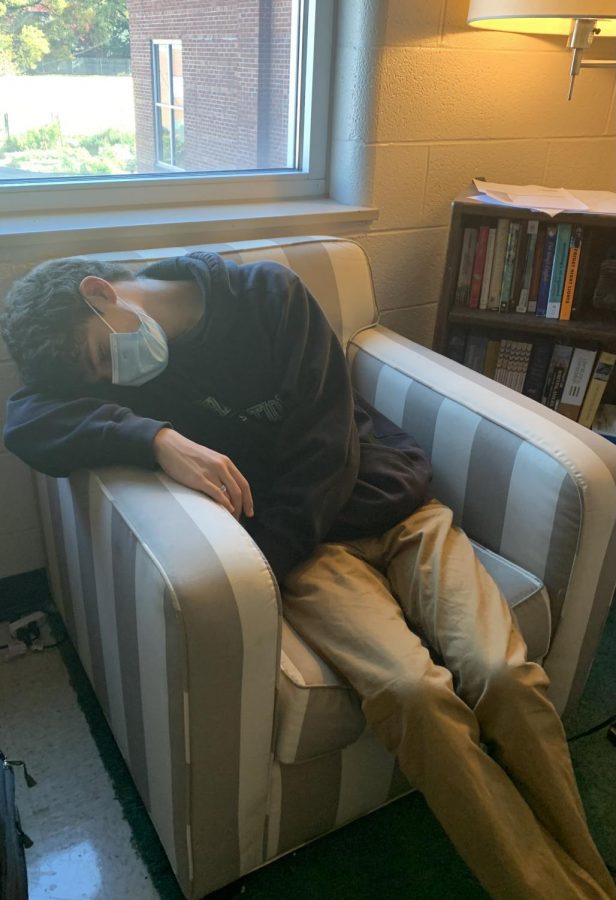 Collapsed on a comfy chair, Andy Blumberg (11) takes a quick nap in the middle of his day. Many students relate to the exhaustion from working late and getting little sleep: a phenomenon called revenge bedtime procrastination.
