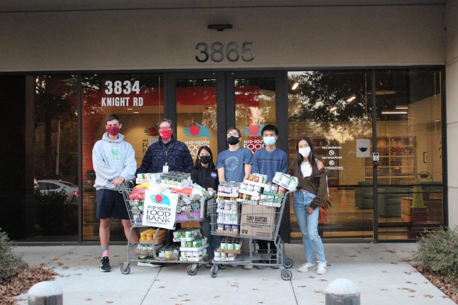 Key Club members stand outside a Mid-South Food Bank warehouse with cart-fulls of cans they’ve collected over the week-long collection period. Together, White Station’s JROTC and Key Club collected over 1,000 cans. 