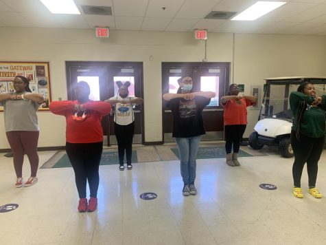Members of the step team stand at the ready while waiting for practice to start (left to right: Ja’Kayla Townsend, Christina Townsend, Riyasha Williams, Kaylen Stafford, Arianna Johnson).
