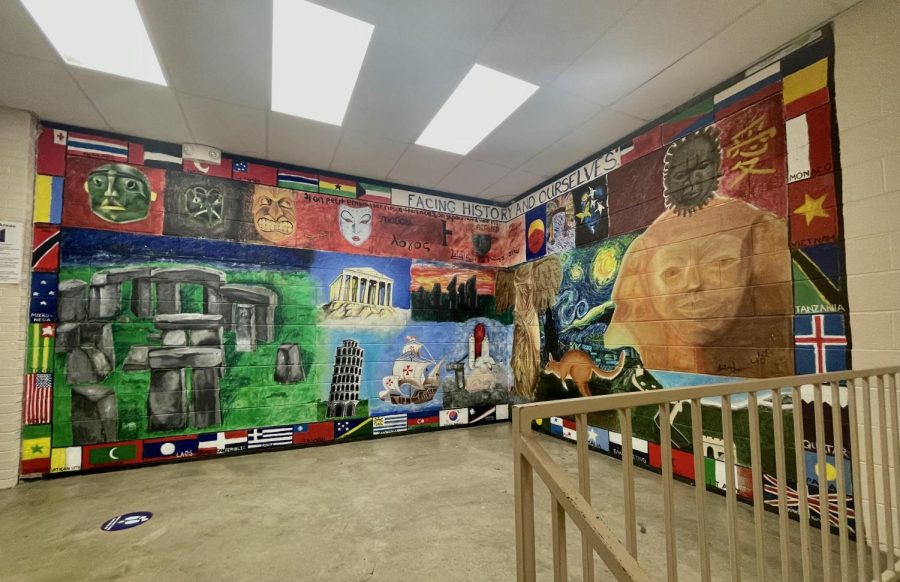 Located+in+one+of+the+most+central+parts+of+the+school%2C+the+Facing+History+and+Ourselves+mural+boasts+its+bright+colors%2C+flashing+its+many+details+to+passing+students.+The+mural+was+created+by+art+students+led+by+Charles+Berlin+30+years+ago.%0A