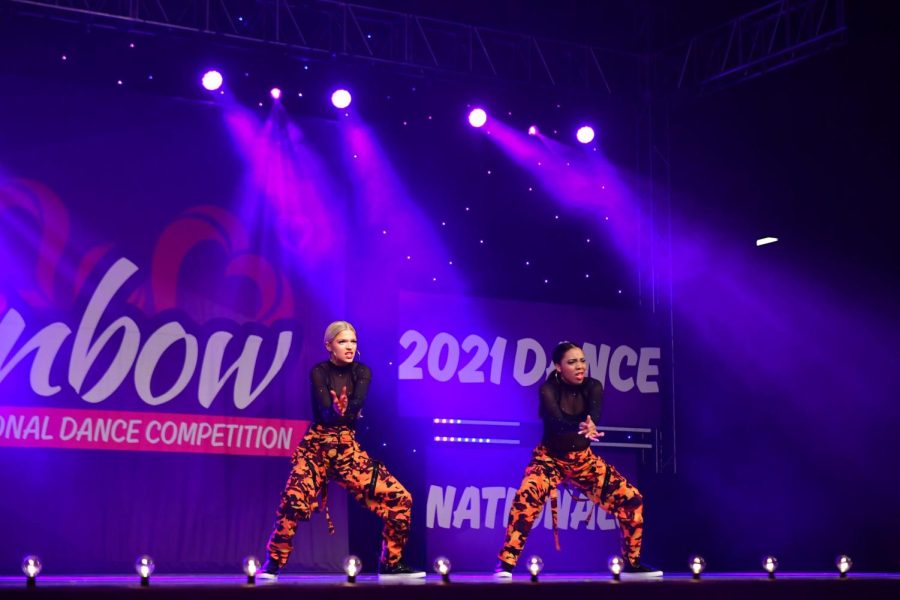 Sarina Milman (12) and her teammate Lea Walker (10) perform at the 2021 Rainbow National Dance Competition. Milman and Walker energetically maneuver their bodies to show the audience the hip-hop routine they have been perfecting for months.