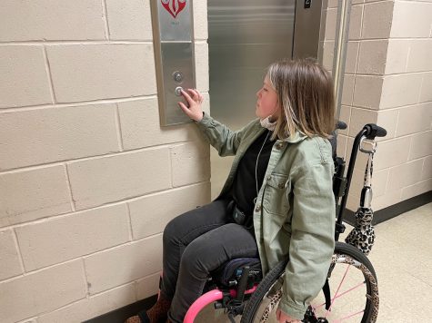 Getting ready to transition to her next class, Annabelle Hulgan (11) presses the elevator button to go down to the first floor. At White Station, there are two elevators — one located in the Main Building and the other in the Freshman Academy. 
