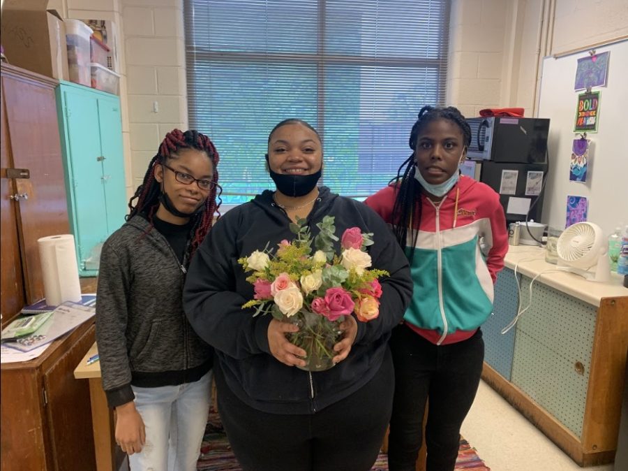 Breyona Golden (10), Tamia Andrews (12) and Mikayla Lott (12) pose with a beautiful bouquet made by Kemm Browne’s functional skills class. As students with disabilities take the lead and put together multicolored roses, leafy stems and vibrant flowers, they develop responsibility and decision-making skills as well as spread joy within the White Station community.