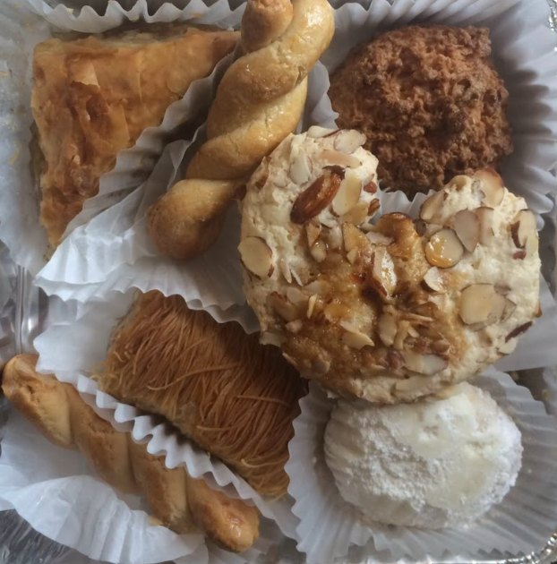 (From top left going clockwise) Baklava, koulouria, endokaridia, ergolavi, kourambiethes and kataifi are some of the pastries available at the Memphis Greek Festival. Volunteers work to prepare and pack the pastries for the community to purchase. 
