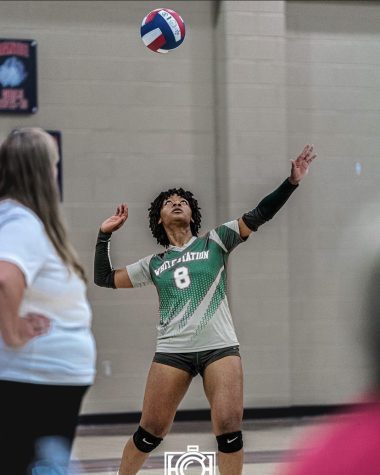 Shakira Townsend (12) serves the ball at the district championship against SBA on September 22nd. They won 3 serves out of 5 that day.
