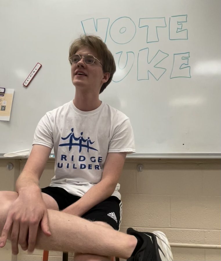  Luke Hatler (11) poses in front of a white board endorsing his campaign.