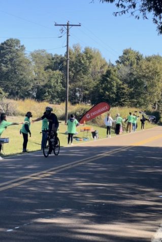 White Station Key Club members hand out food and water to cyclists for a quick endurance boost. Volunteers distributed supplies and cheered on more than 1,100 athletes as they raced through their station.