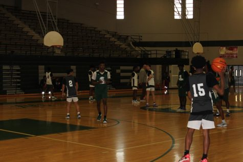 Coach Pattino leads basketball practice. Players practice through the 7th period to after school in the senior gym.