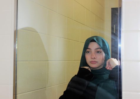 Narjis Alabes (11) adjusts her hijab to ensure her hair is fully covered. Many hijabis do the same to uphold their religious practices of modesty. 