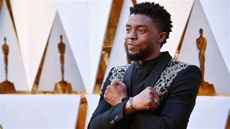 With a Wakanda Forever salute, Chadwick Boseman poses at the Emmys. After the release of Black Panther in 2018, Wakanda Forever became a symbol for Black pride.