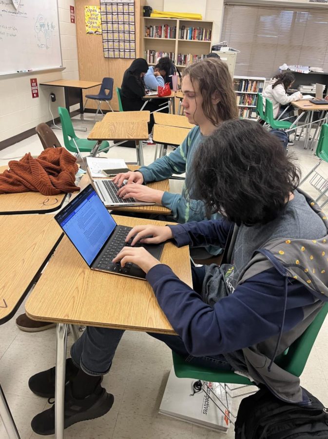 Eli Duncan (12) and Fields Bell (11) work on a writing assignment. Students enrolled in the genre literature class complete objective, analysis-based writing assignments as well as creative writing assignments, like rewriting sections of text from short stories studied in class.
