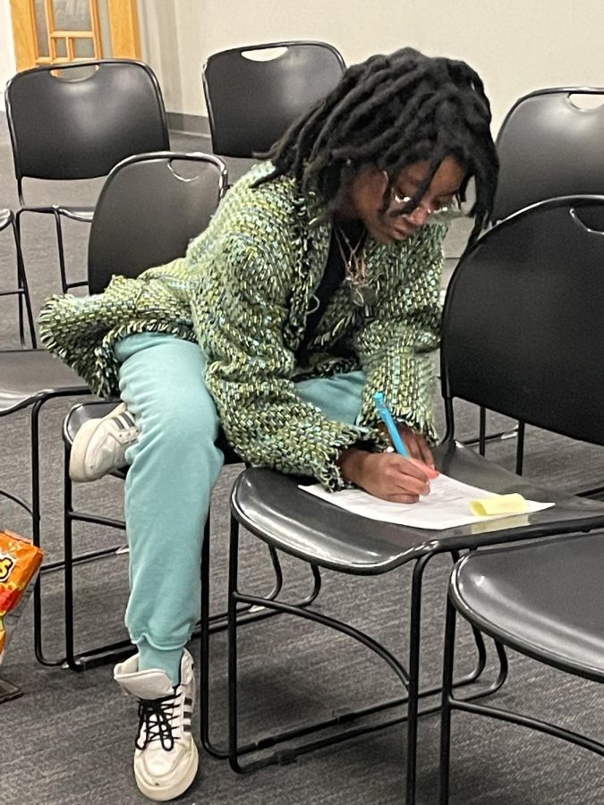  Morgan Yates (11) works on judging one of the writing contest submissions. The judging system was anonymous, allowing the work to be viewed solely on creativity and writing skills.

