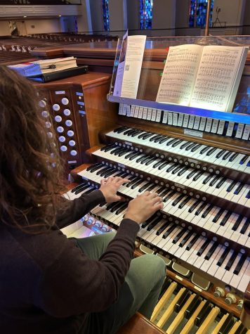 John Michael Pfrommer (11) plays the organ. The complex instrument consists of keyboards and pedals as well as various stops that alter the sound. 

